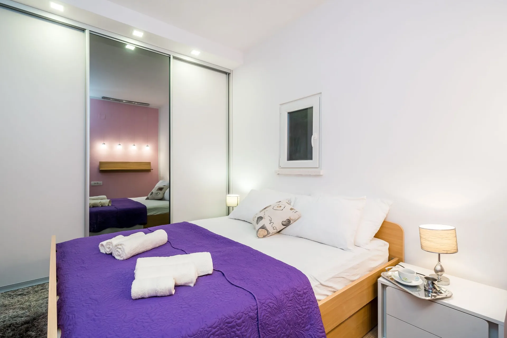 luciana residence bedroom purple bedding wardrobe