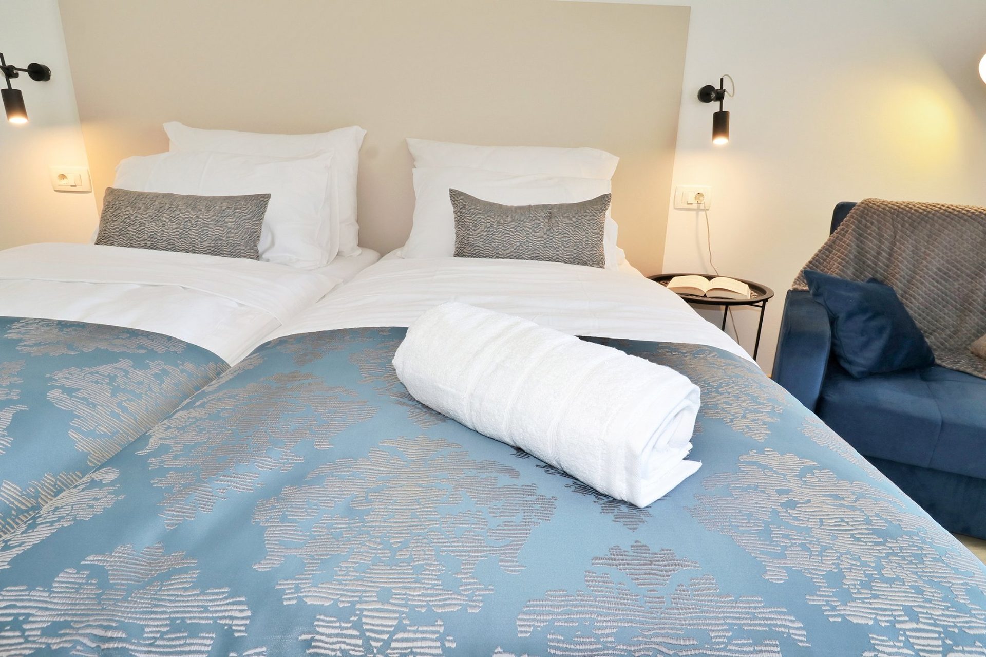 magico apartments bedroom twin towels blue duvet