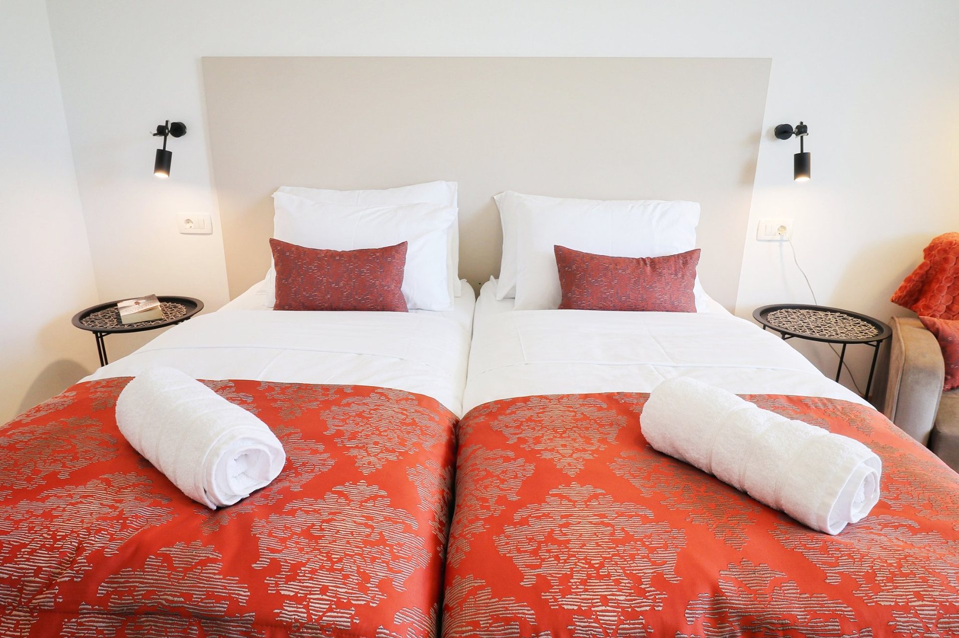 magico apartments twin beds red bedding headboard